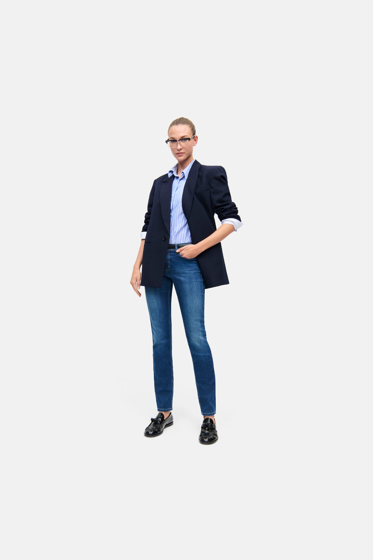 Dunkelblaue Slim-Fit-Jeans aus 92 % Baumwolle, 6 % Elastomultiester und 2 % Elasthan, getragen in einem eleganten Businessumfeld.