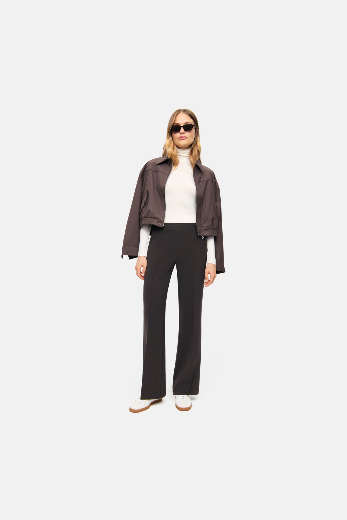 Dunkelbraune Wide Leg Hose aus 90% Polyester und 10% Polyurethan, getragen von einer Person in einem urbanen Szenario.