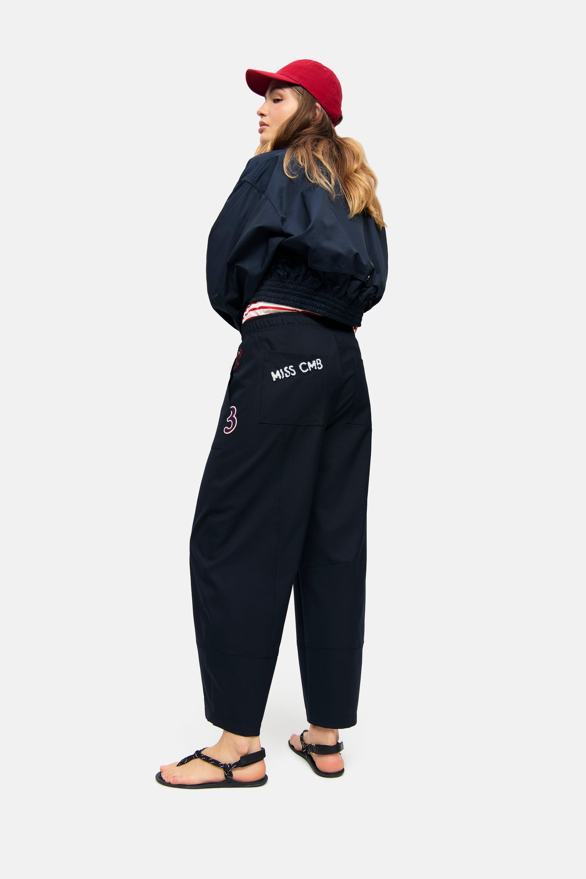 Dunkelblaue O-Shape Hose aus 67% Polyester, 29% Viskose, 4% Elasthan, mit weitem Bein und elastischem Bund, im urbanen Setting getragen.