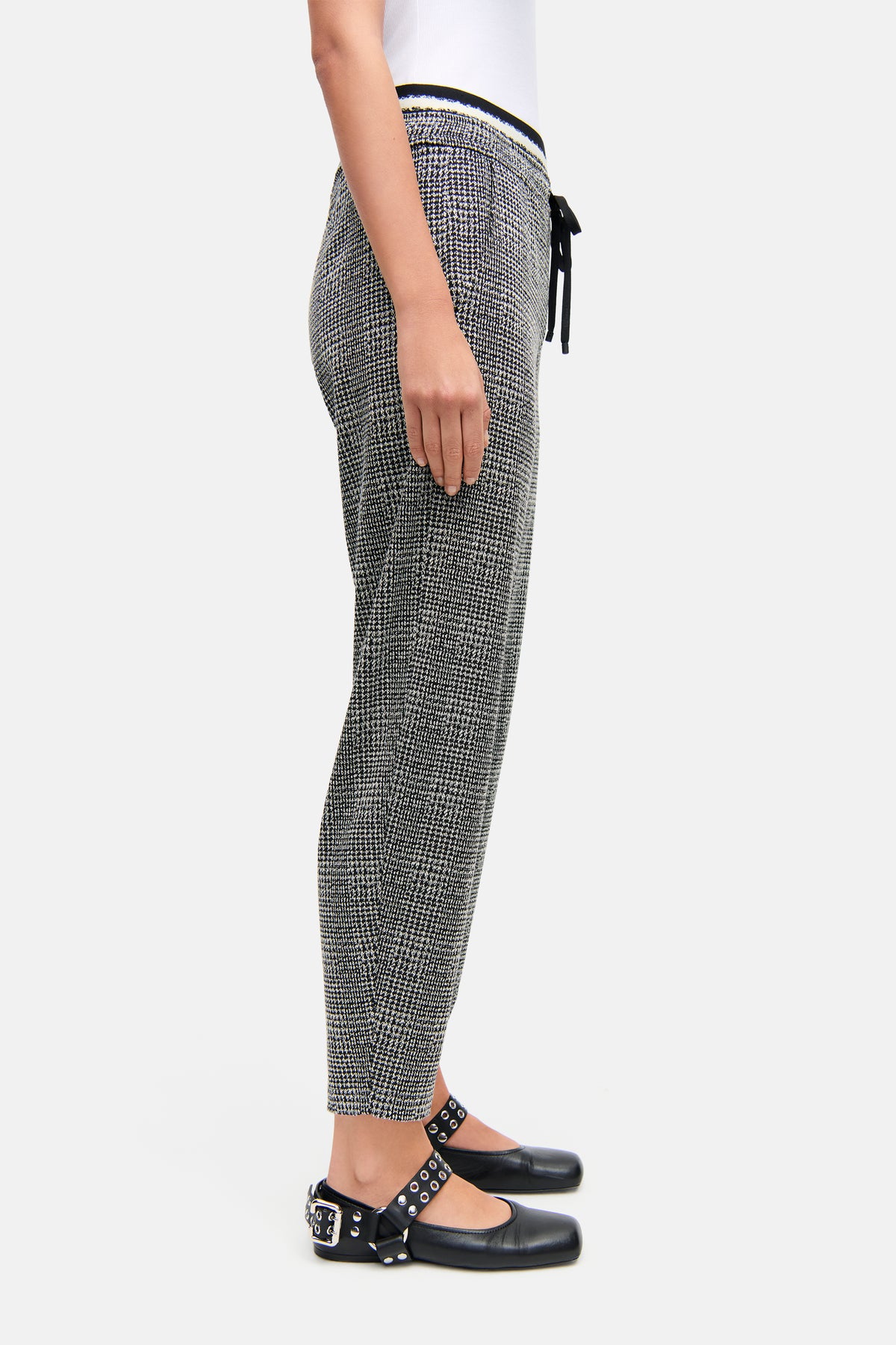 Damen trägt verkürzte O-Shape Hose in schwarz-weißer Glencheck-Musterung aus 52% Viskose, 44% Polyamid, 4% Elasthan.