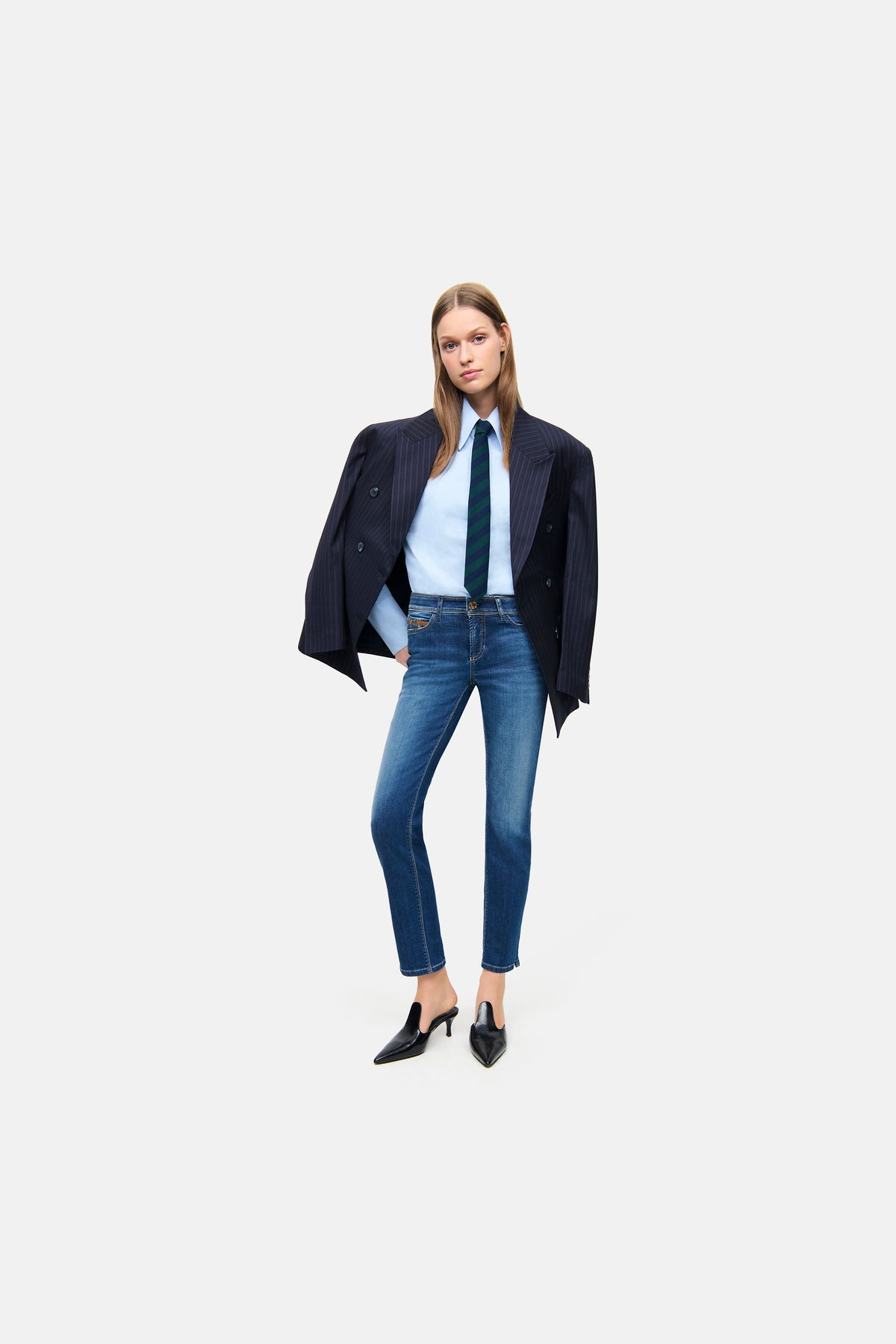 Blaue Slim-Fit-Jeans aus 92% Baumwolle, 6% Elastomultiester T400 und 2% Elasthan. Getragen in Büro-Setting mit Blazer. 
