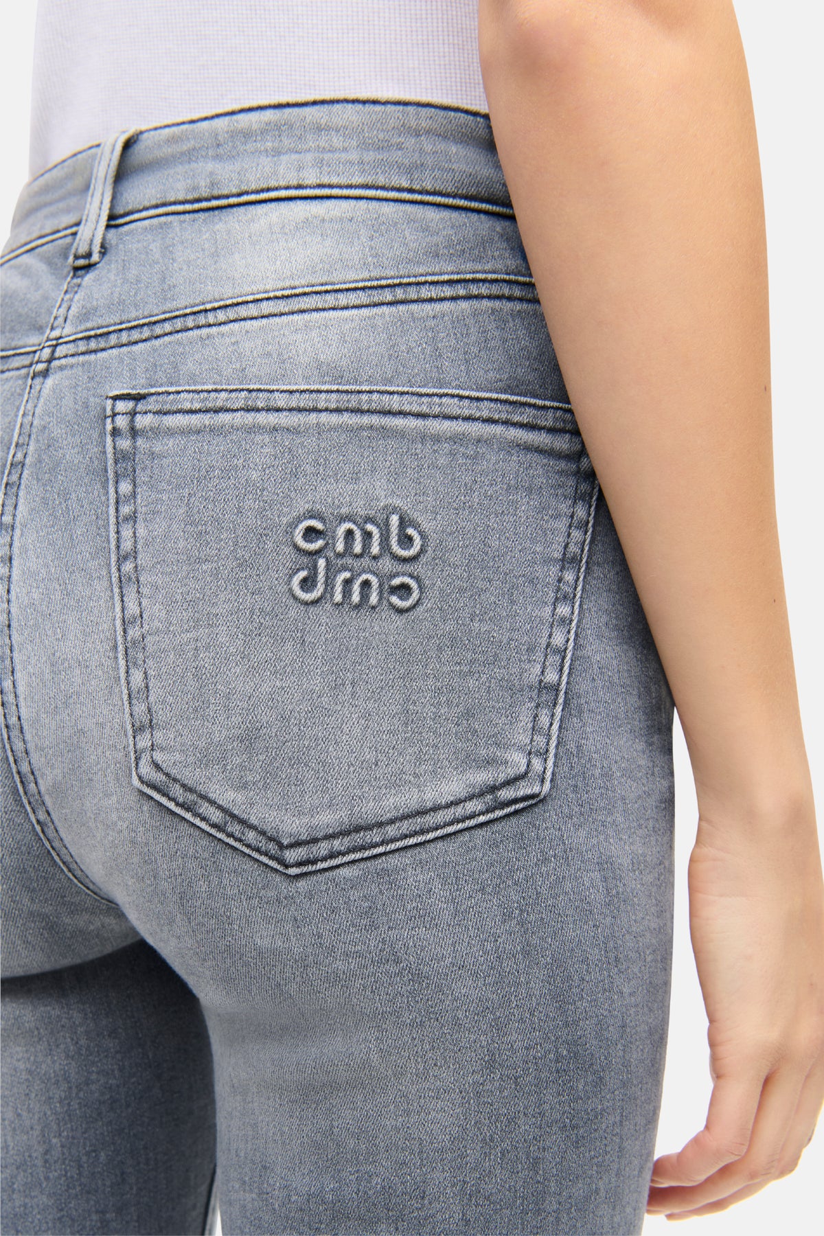 Hellgraue Skinny-Fit-Jeans aus Baumwolle, Elastomultiester, Elasthan und Lyocell, getragen von einer Person.